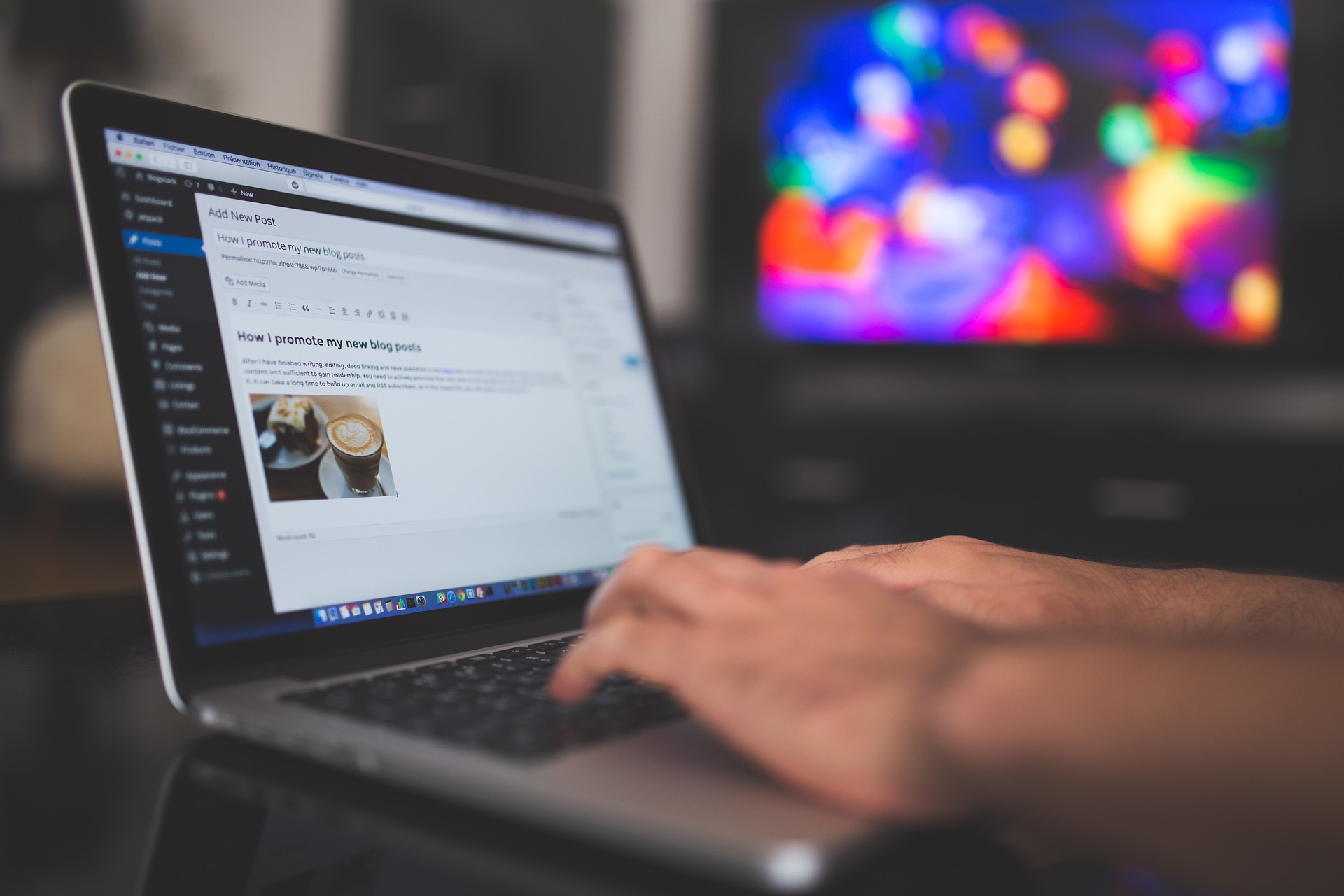 Person typing on laptop, WordPress interface